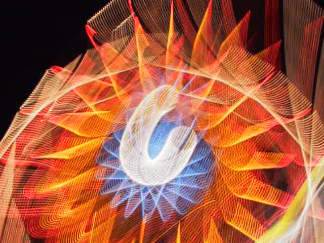 light painting, digital photography, ferris wheel in motion with combined camera movement