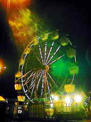 Exact positioning of camera under street lamp over ferris wheel.